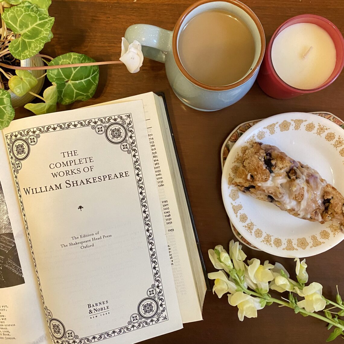Book on table with coffee and pastry